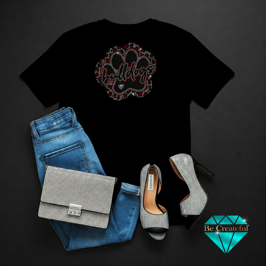Black t-shirt with Bulldog paw graphic design, blue jeans, silver handbag, and high heels on a dark background.