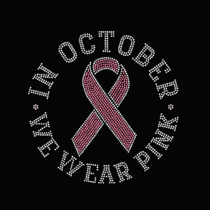Pink breast cancer awareness ribbon with 'In October we wear pink' text on a black background