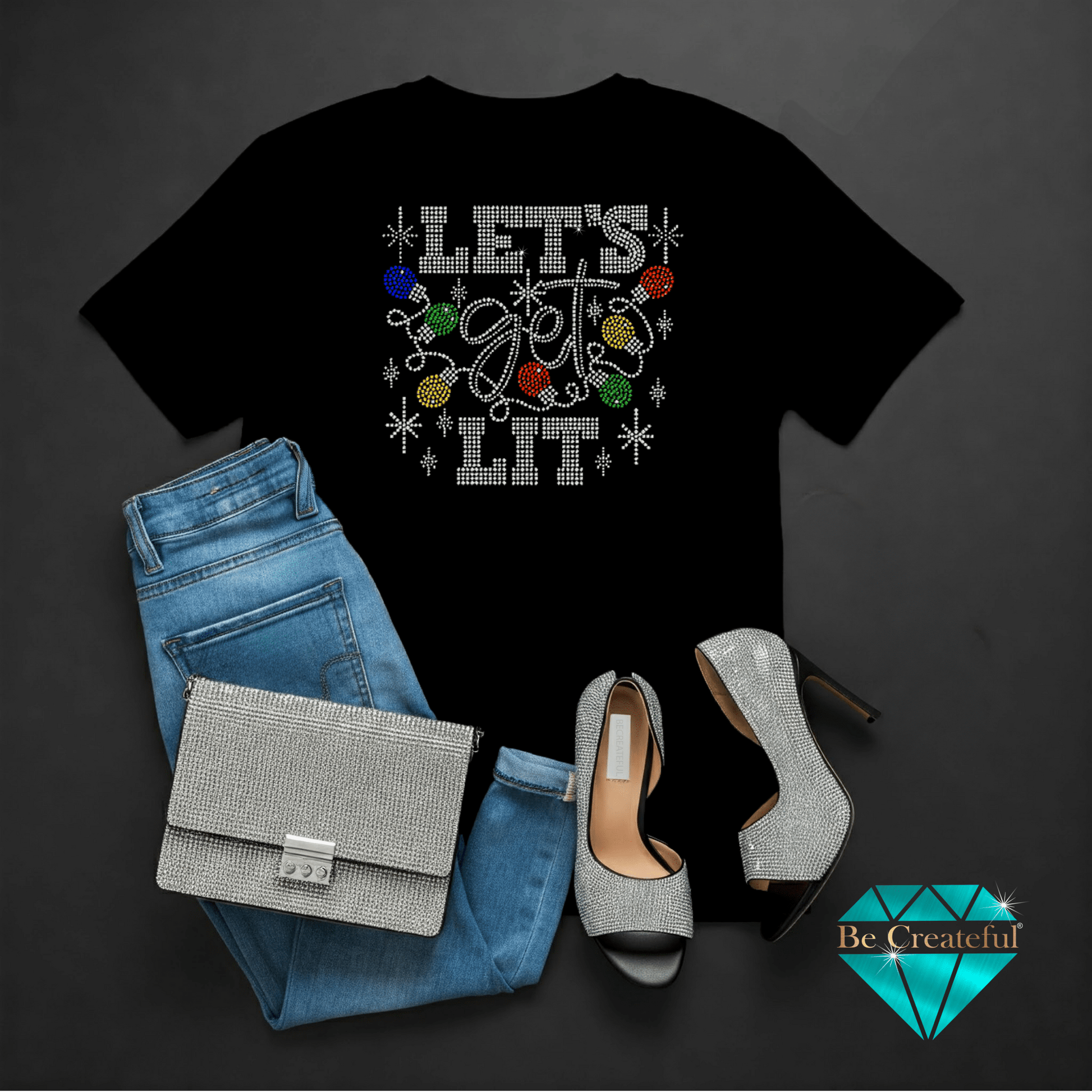 Black t-shirt with 'Let's Get Lit' design, blue jeans, silver handbag, and high heels on a dark background.
