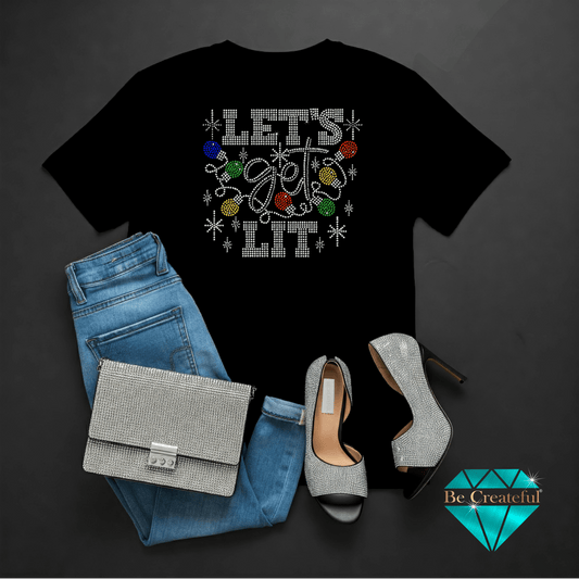 Black t-shirt with 'Let's Get Lit' design, blue jeans, silver handbag, and high heels on a dark background.