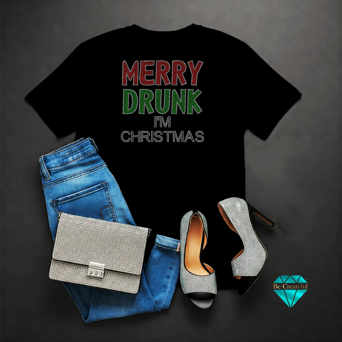 A black shirt with 'MERRY DRUNK I'M CHRISTMAS' rhinestone design