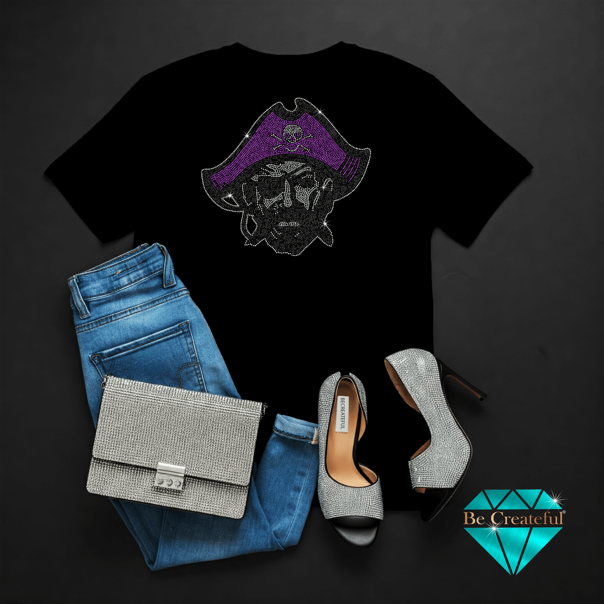 Black t-shirt with pirate design, blue jeans, silver handbag, and high heels on a dark background.