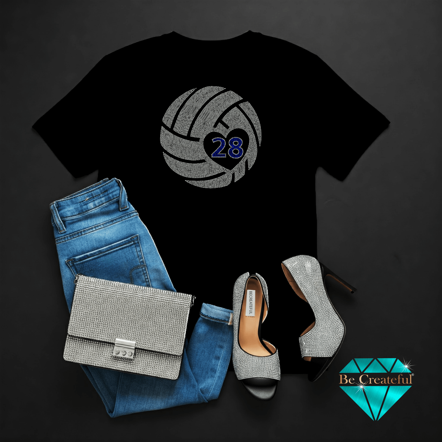 Black t-shirt with rhinestone volleyball design, blue jeans, silver handbag, and high heels.