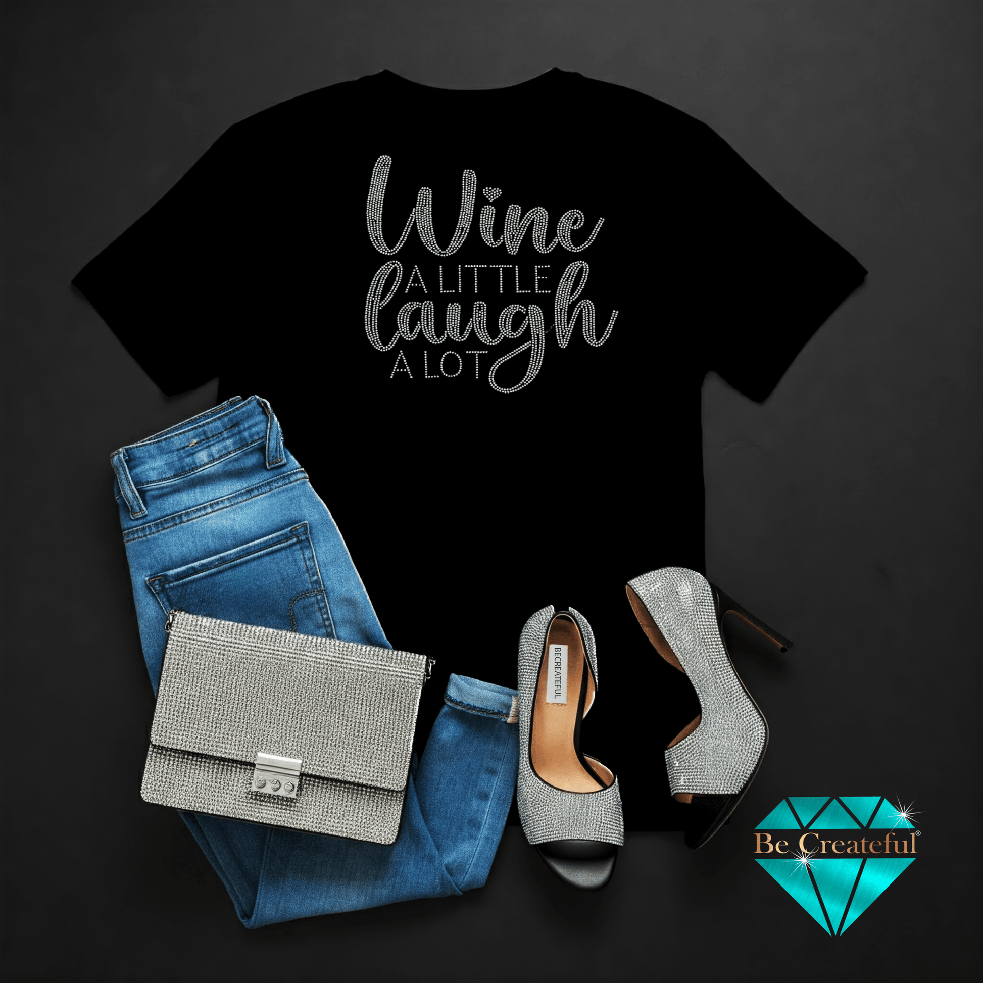 Black t-shirt with 'Wine A Little Laugh A Lot' text, blue jeans, on a dark background.