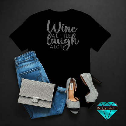 Black t-shirt with 'Wine A Little Laugh A Lot' text, blue jeans, on a dark background.