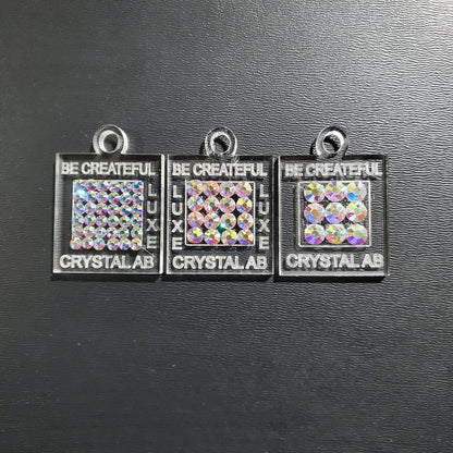 Acrylic charms to create rhinestone color swatches.